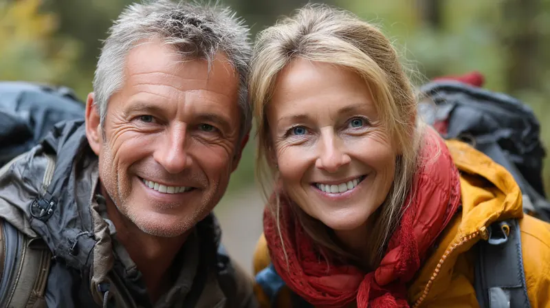 A middle-aged couple smiling together on a mountain hike